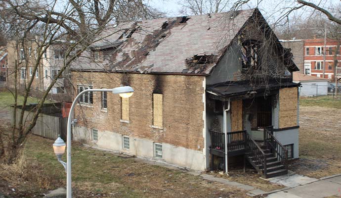 Boarded-up fire damaged home