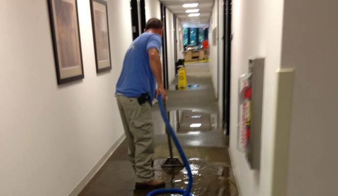 Cleaning hallway water damaged floor with equipment