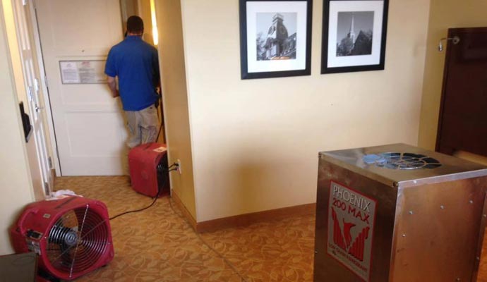 Water damaged floor drying by fan