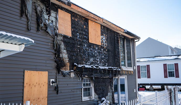 Boarded-up fire damaged house