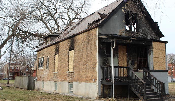 Fire damaged boarded-up house