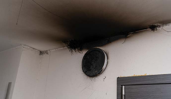 Soot damage on ceiling and wall