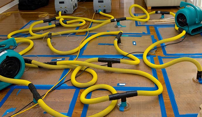 Water damage restoration service using equipment