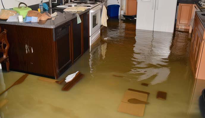 Murky flood water covering the floor in a home interior