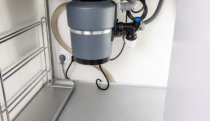 Installed garbage disposal unit under kitchen sink