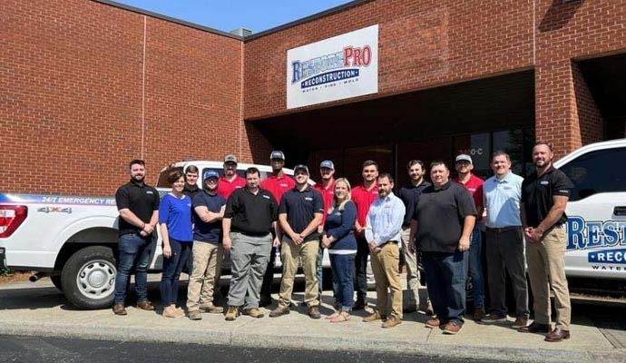 RestorePro Reconstruction team members standing in front of office