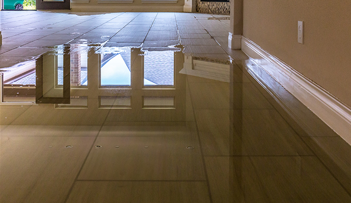 A tiled floor in a home covered in standing water