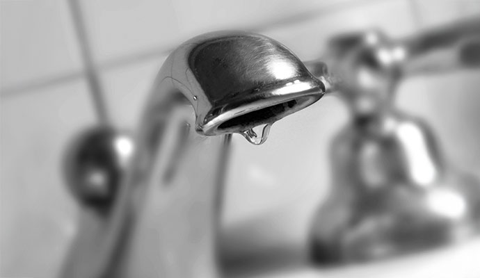 Dripping water from leaky faucet