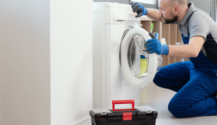 Expert inspecting washing machine