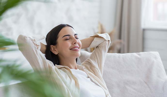 A woman enjoying good indoor air quality after smoke odor removal service
